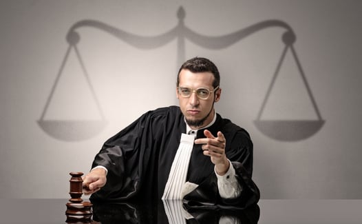 Young handsome judge in black gown making decision